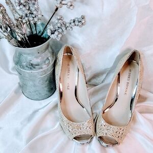 Audrey Brooke | Silver and gold threaded peep-toed heels.
